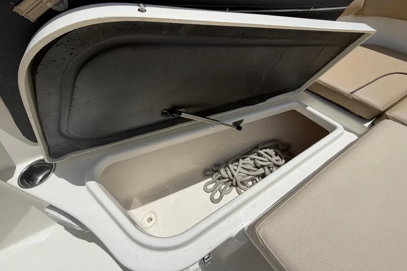 Slide: The Image of An open storage compartment on a boat with a rope inside. - 49