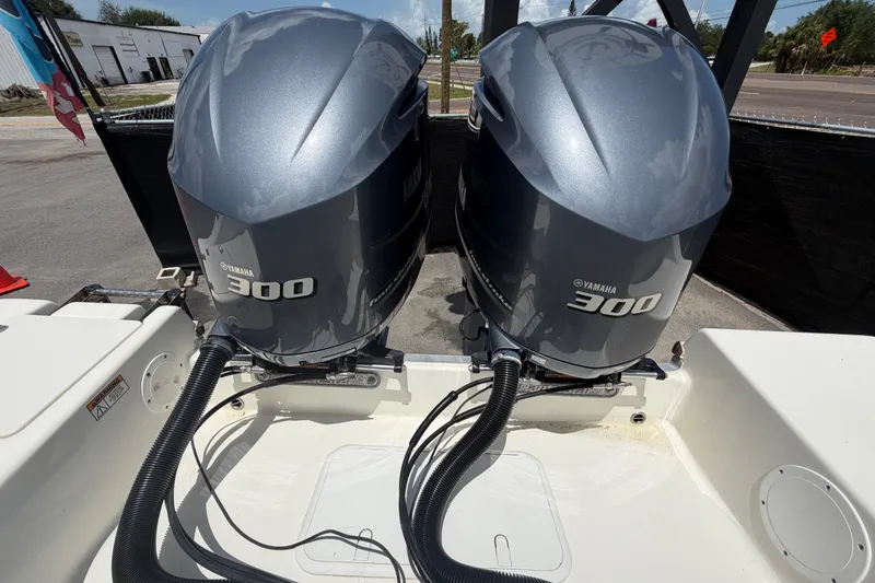 Slide: The Image of Twin Yamaha 300 engines on a 2018 NauticStar 28 XS boat, parked outdoors. - 80