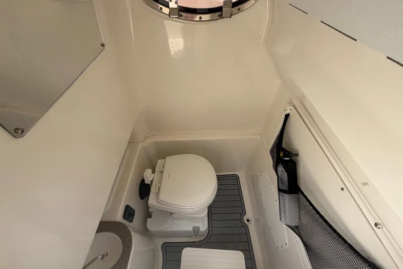 Slide: The Image of 2018 NauticStar 28 XS boat interior bathroom with toilet and sink. - 43