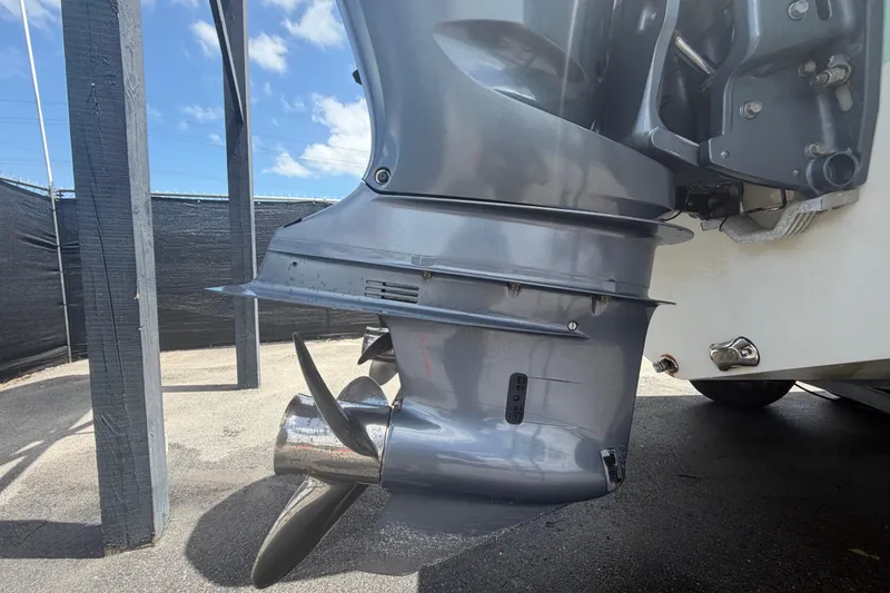 Slide: The Image of 2018 NauticStar 28 XS boat motor with propeller, parked outdoors. - 8