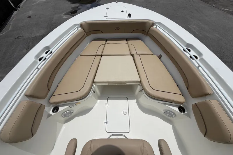 Slide: The Image of The image shows the bow area of a 2018 NauticStar 28 XS with beige cushions. - 46