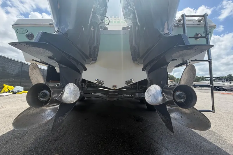 Slide: The Image of 2018 NauticStar 28 XS boat with dual outboard motors and propellers, viewed from the rear. - 5