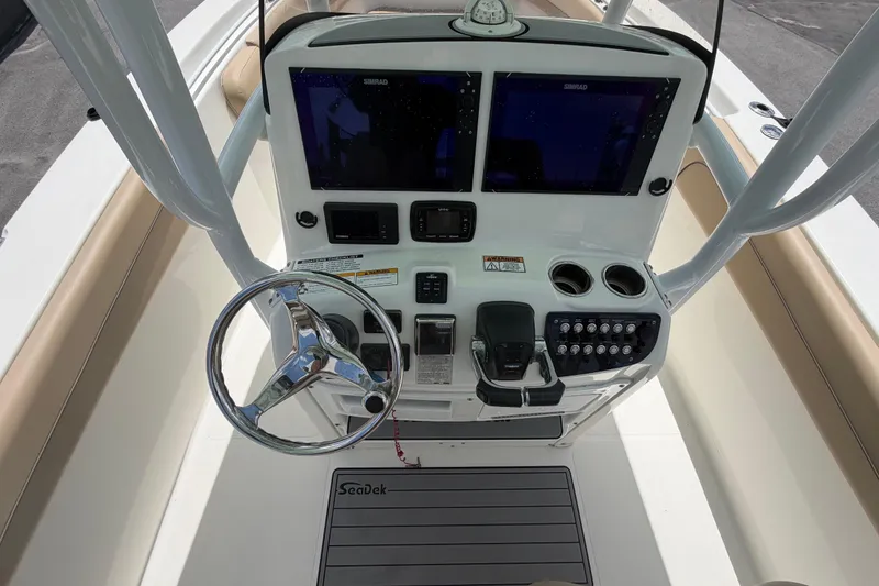 Slide: The Image of 2018 NauticStar 28 XS boat console with dual Simrad displays and steering wheel. - 28