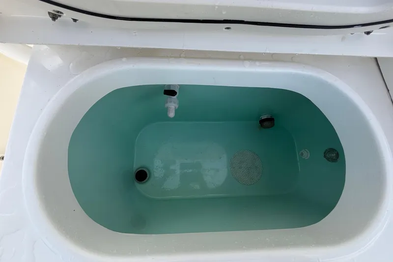 Slide: The Image of An oval, white boat livewell filled with water, showing drain and aeration features. - 21