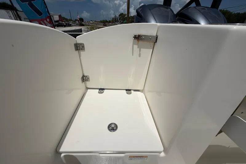 Slide: The Image of 2018 NauticStar 28 XS boat deck with storage compartment and dual engines. - 69