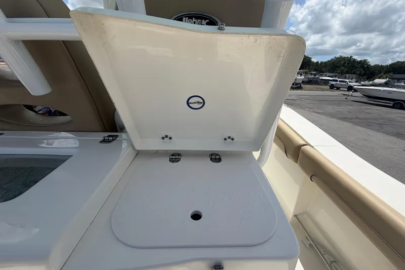 Slide: The Image of Open storage compartment on 2018 NauticStar 28 XS boat, with visible hinges and latch. - 22