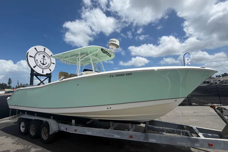 The Image of 2018 NauticStar 28 XS boat on trailer under blue sky. - 0
