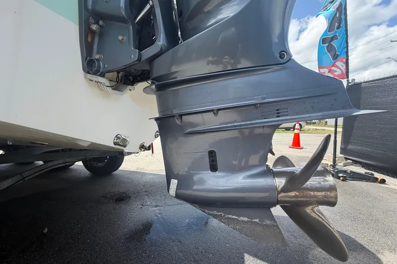 Slide: The Image of 2018 NauticStar 28 XS boat engine and propeller close-up on pavement. - 9