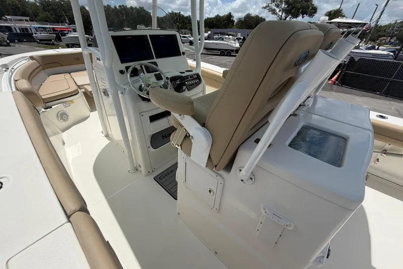 Slide: The Image of 2018 NauticStar 28 XS boat interior with helm, seating, and navigation equipment. - 25