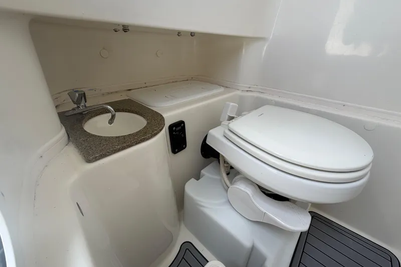 Slide: The Image of 2018 NauticStar 28 XS boat bathroom with sink and toilet. - 44