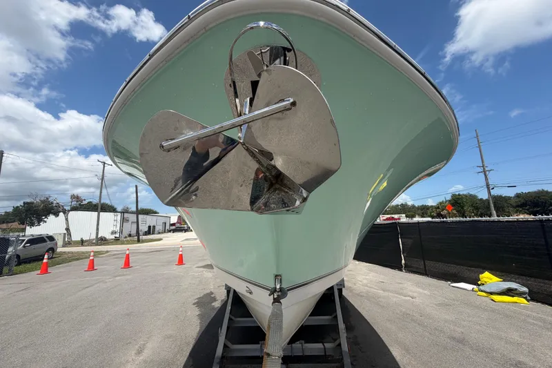 Slide: The Image of 2018 NauticStar 28 XS boat on trailer, shiny anchor, clear sky background. - 14