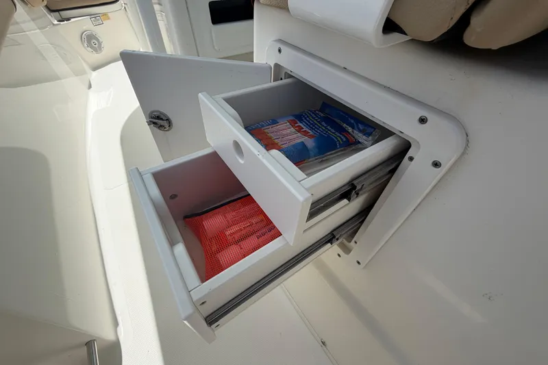 Slide: The Image of Storage drawers on a 2018 NauticStar 28 XS boat, containing safety equipment. - 27