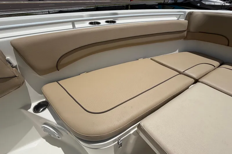 Slide: The Image of 2018 NauticStar 28 XS boat with beige cushioned seating and cup holders. - 48