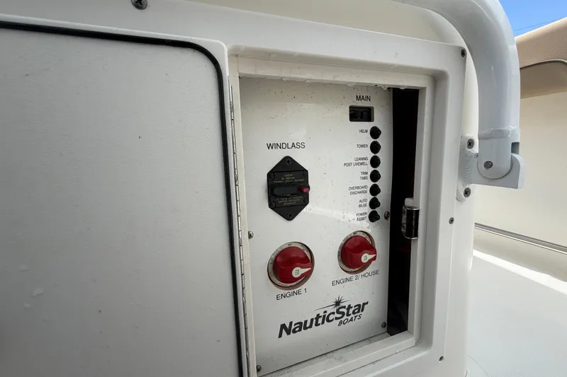 Slide: The Image of Control panel of a 2018 NauticStar 28 XS boat, featuring engine and windlass switches. - 62