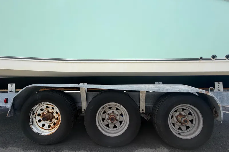 Slide: The Image of 2018 NauticStar 28 XS boat on a triple-axle trailer, side view. - 83