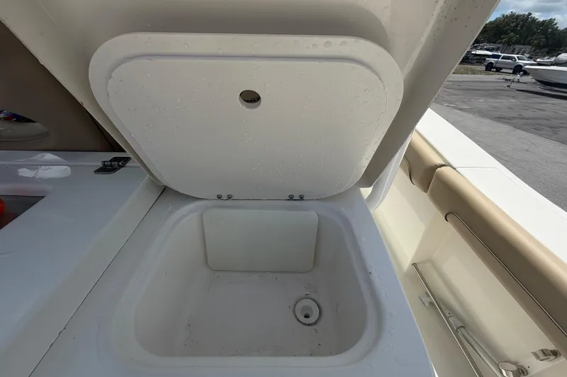 Slide: The Image of Open storage compartment on a 2018 NauticStar 28 XS boat, showing interior details. - 23