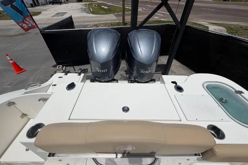 Slide: The Image of 2018 NauticStar 28 XS boat with twin 300 horsepower engines, rear view. - 77