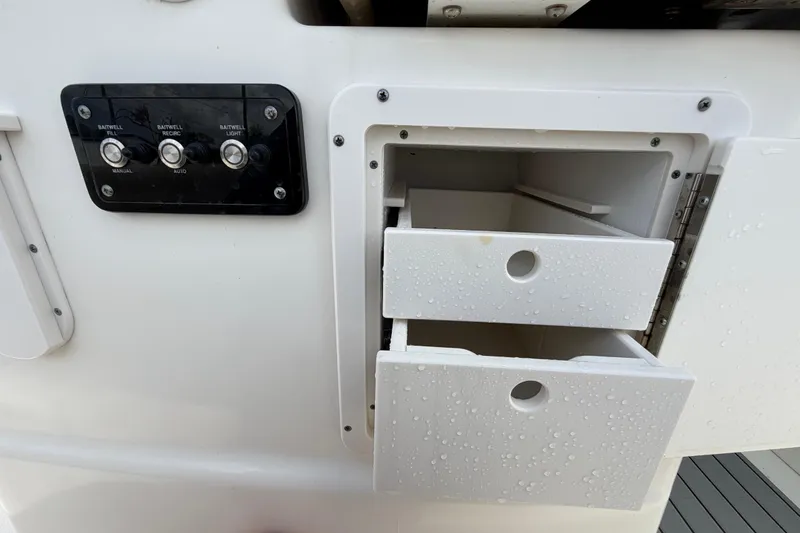 Slide: The Image of 2018 NauticStar 28 XS boat with wet storage drawers and control panel. - 66