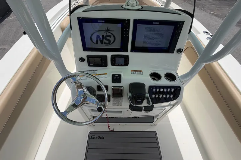 Slide: The Image of 2018 NauticStar 28 XS boat console with dual Simrad displays and steering wheel. - 29