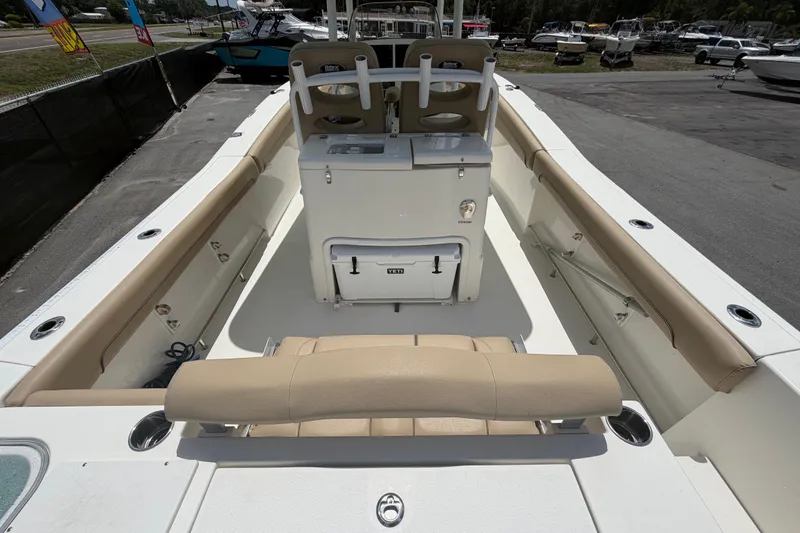Slide: The Image of 2018 NauticStar 28 XS boat interior with beige seating and storage compartments. - 18