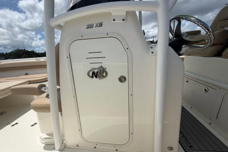 Slide: The Image of 2018 NauticStar 28 XS boat interior with steering wheel and seating. - 42