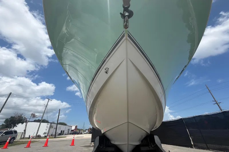 Slide: The Image of 2018 NauticStar 28 XS boat viewed from below against a blue sky. - 15