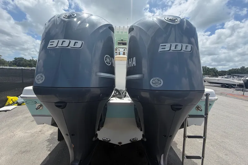 Slide: The Image of 2018 NauticStar 28 XS boat with dual Yamaha 300 engines, parked outdoors. - 4