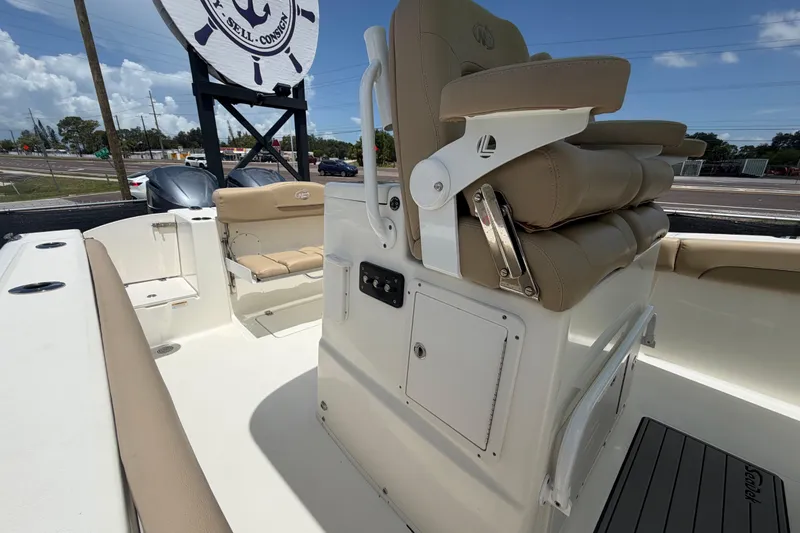 Slide: The Image of 2018 NauticStar 28 XS boat interior with beige seating and console. - 64