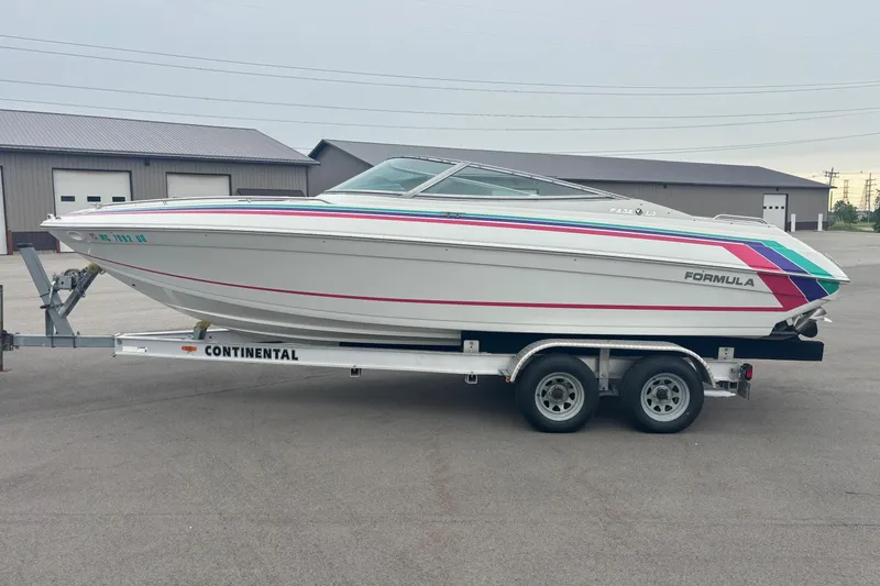 The Image of 1994 Formula 232 LS boat on Continental trailer, parked outdoors. - 0