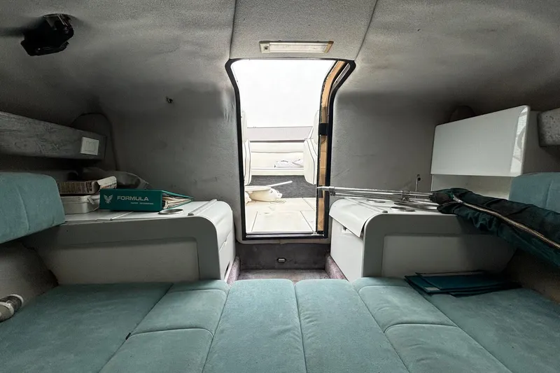 Slide: The Image of Interior of a 1994 Formula 232 LS boat cabin with seating and storage. - 16
