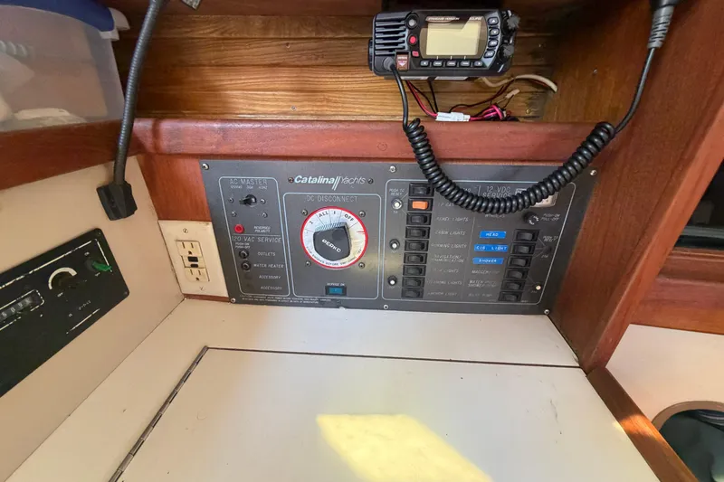 Slide: The Image of Electrical control panel of a 1988 Catalina 34 yacht with radio and switches. - 14