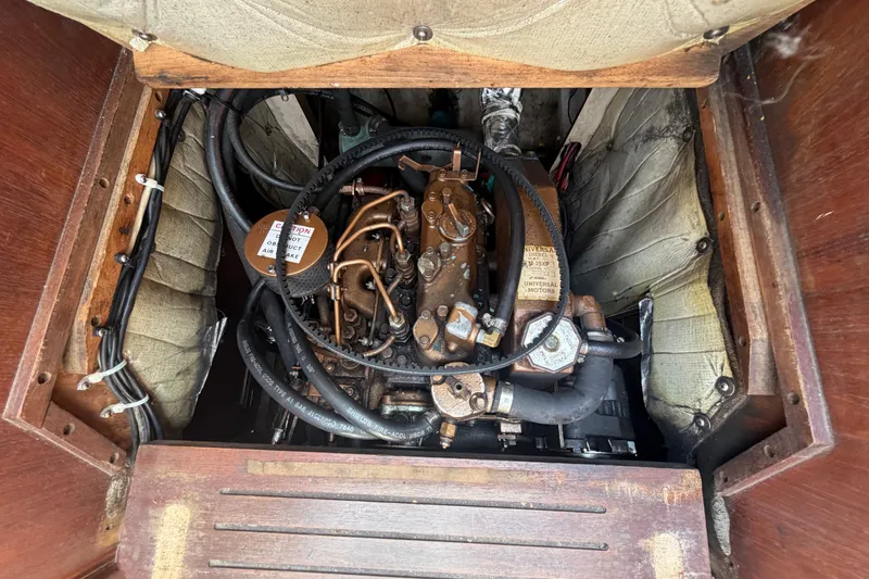 Slide: The Image of Engine compartment of a 1988 Catalina 34 sailboat, showcasing mechanical components and wiring. - 16