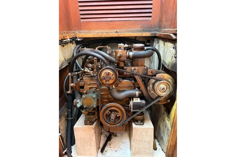 Slide: The Image of Engine of a 1988 Catalina 34 sailboat, showing belts and hoses. - 17