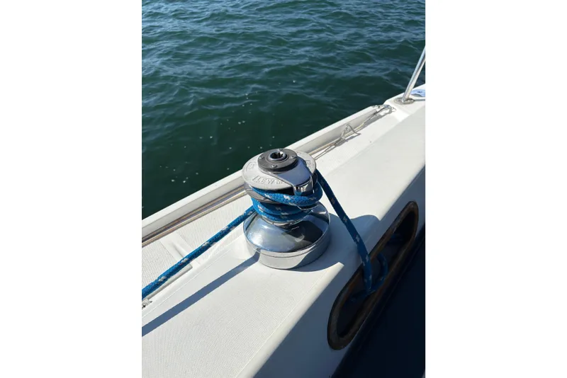 Slide: The Image of Winch on 1988 Catalina 34 sailboat with blue rope, ocean background. - 18