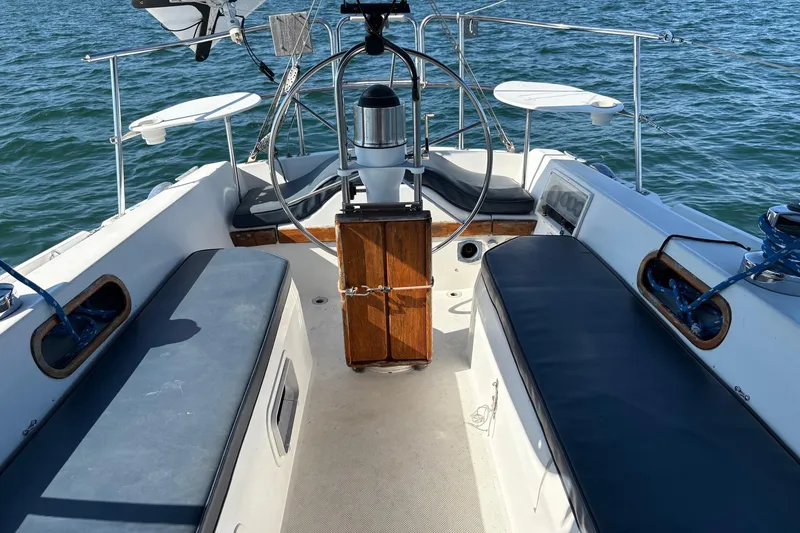 Slide: The Image of Cockpit of 1988 Catalina 34 sailboat with steering wheel and seating, on open water. - 21
