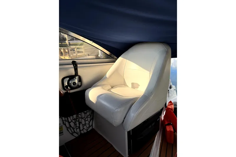 Slide: The Image of Captain's seat on 2011 Regal 2565 Express Cruiser, featuring a sleek design and comfortable upholstery. - 3