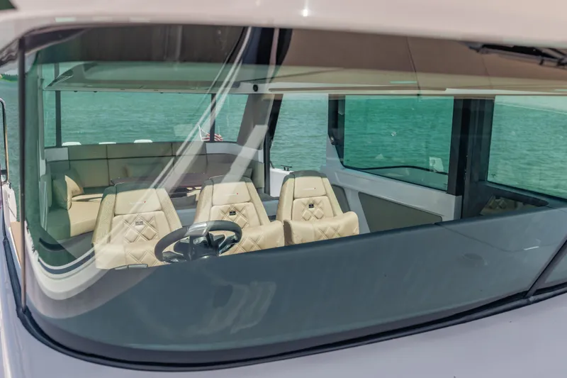 Slide: The Image of Interior view of 2027 Axopar 45 XC Cross Cabin with luxurious seating and steering wheel. - 15
