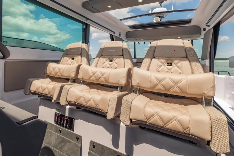 Slide: The Image of Luxurious interior seating of 2027 Axopar 45 XC Cross Cabin with beige leather upholstery. - 14