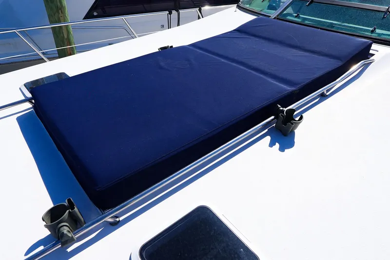 Slide: The Image of Sunpad on 1998 Sea Ray 500 Sundancer yacht, featuring blue cushion and stainless steel railings. - 12