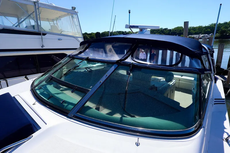 Slide: The Image of 1998 Sea Ray 500 Sundancer yacht docked, featuring sleek design and spacious interior. - 13