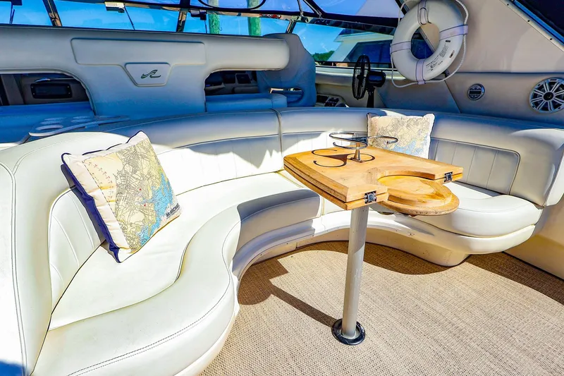 Slide: The Image of Luxurious interior of 1998 Sea Ray 500 Sundancer yacht with plush seating and wooden table. - 18