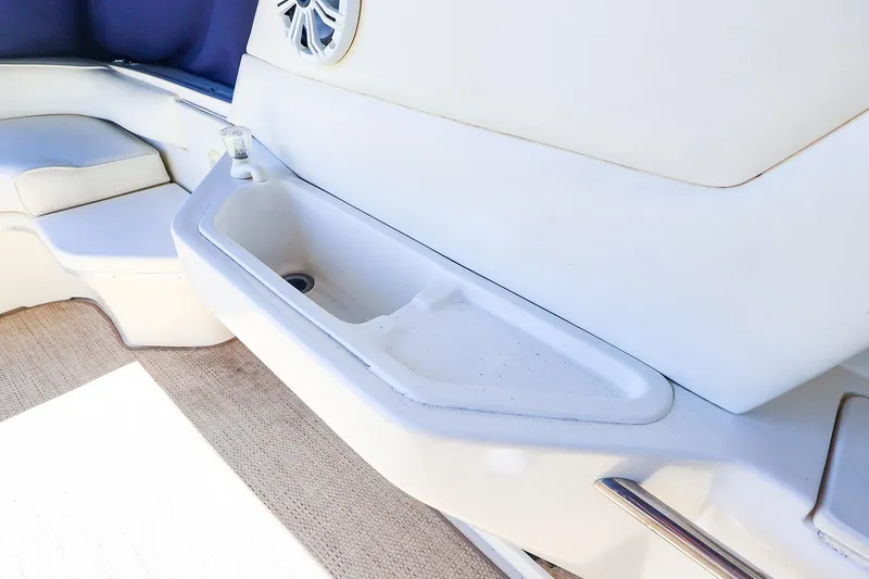 Slide: The Image of Interior view of a 1998 Sea Ray 500 Sundancer yacht featuring a built-in sink and seating area. - 20