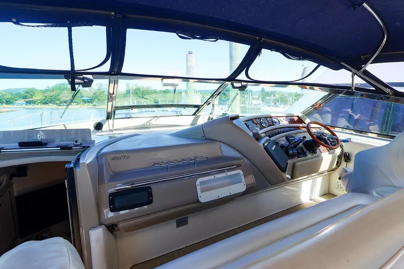 Slide: The Image of Interior view of a 1998 Sea Ray 500 Sundancer yacht cockpit with steering wheel and controls. - 22