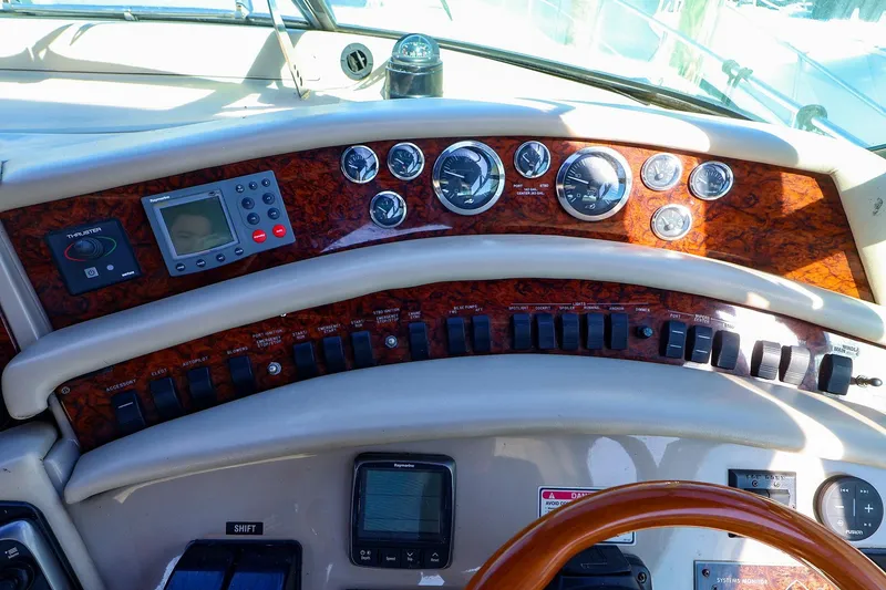 Slide: The Image of Control panel of a 1998 Sea Ray 500 Sundancer yacht with gauges and switches. - 25