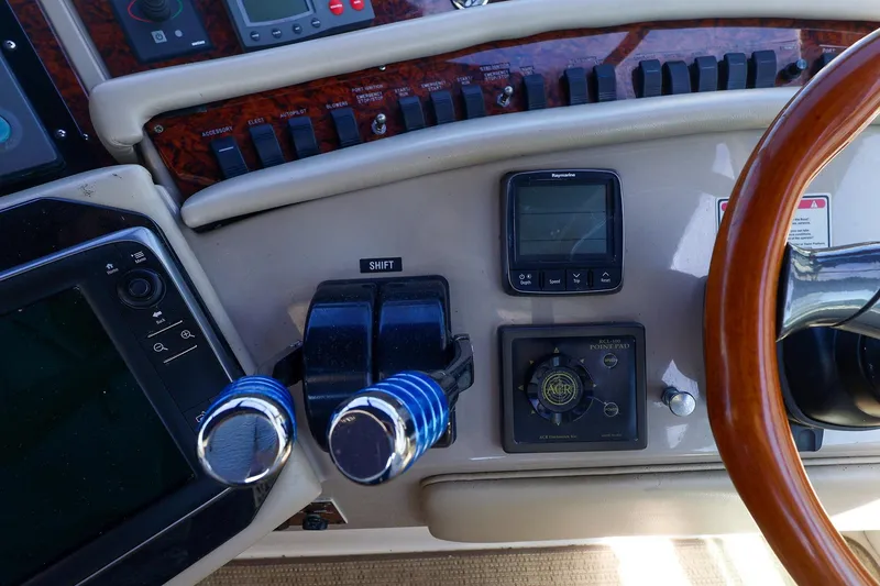 Slide: The Image of Control panel of a 1998 Sea Ray 500 Sundancer yacht with steering wheel and navigation instruments. - 27