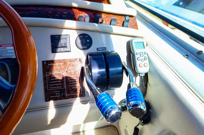 Slide: The Image of Control panel of a 1998 Sea Ray 500 Sundancer yacht with throttle and system monitor. - 28