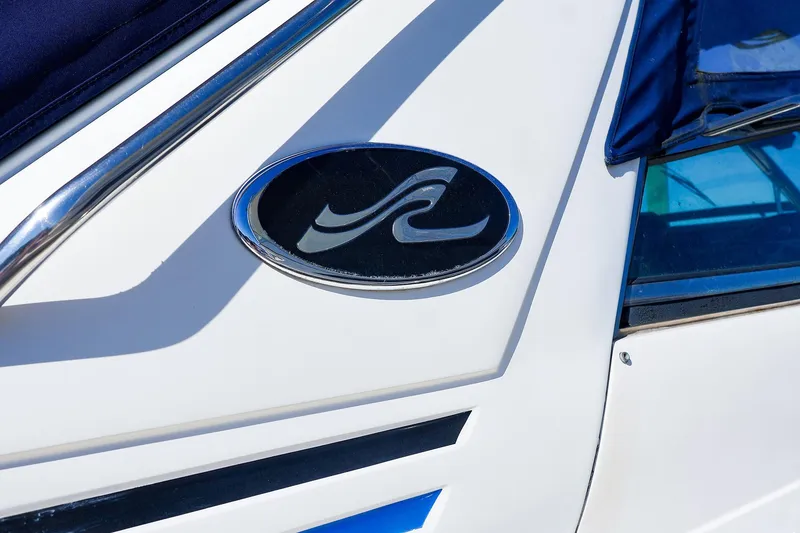 Slide: The Image of Close-up of 1998 Sea Ray 500 Sundancer logo on white boat exterior. - 3