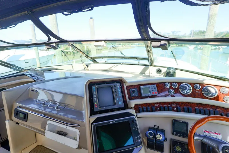 Slide: The Image of Cockpit view of 1998 Sea Ray 500 Sundancer yacht with navigation instruments and steering wheel. - 30