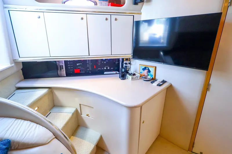 Slide: The Image of Interior of 1998 Sea Ray 500 Sundancer yacht with cabinets and entertainment setup. - 36
