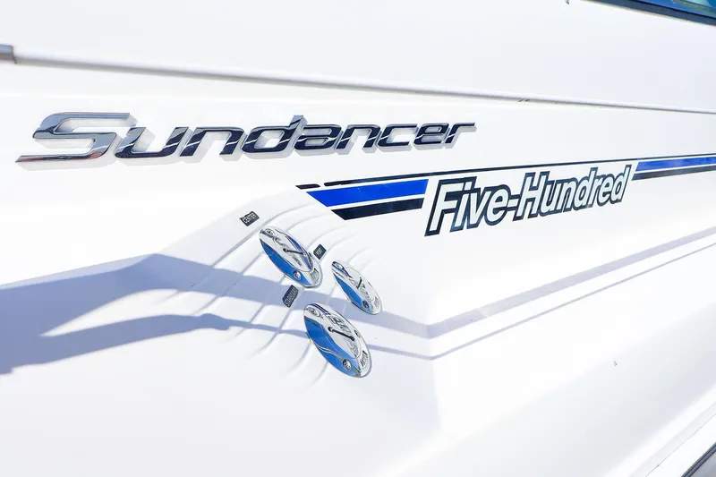 Slide: The Image of 1998 Sea Ray 500 Sundancer boat emblem with sleek design and chrome accents. - 4